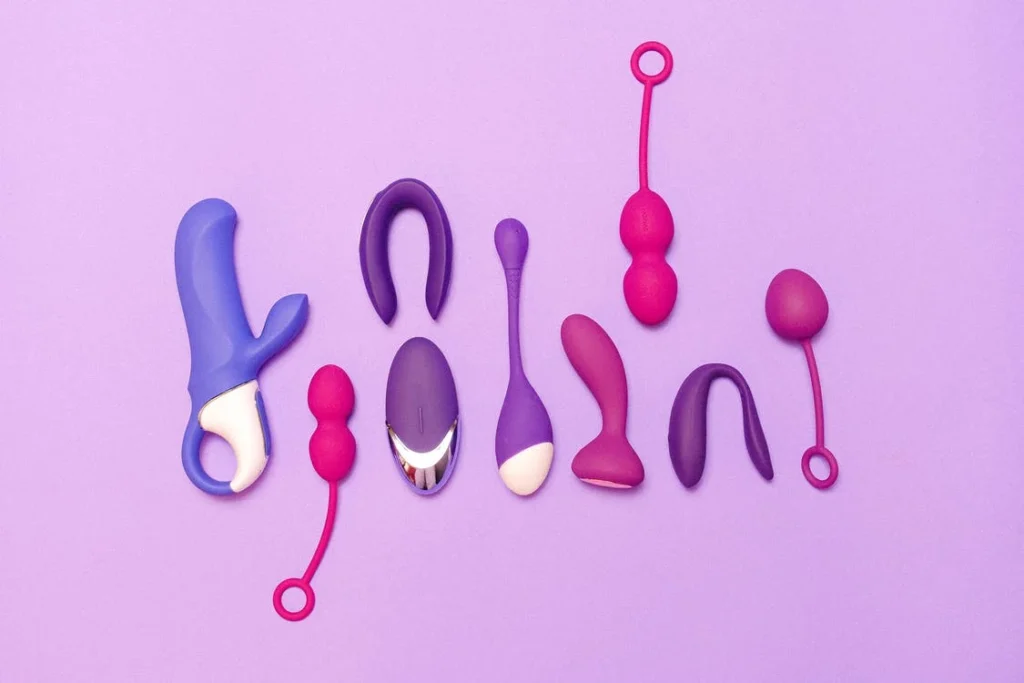 Sex toys and vibrators on purple background